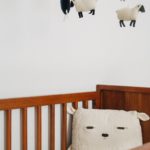 crib with sheep pillow and crib mobile