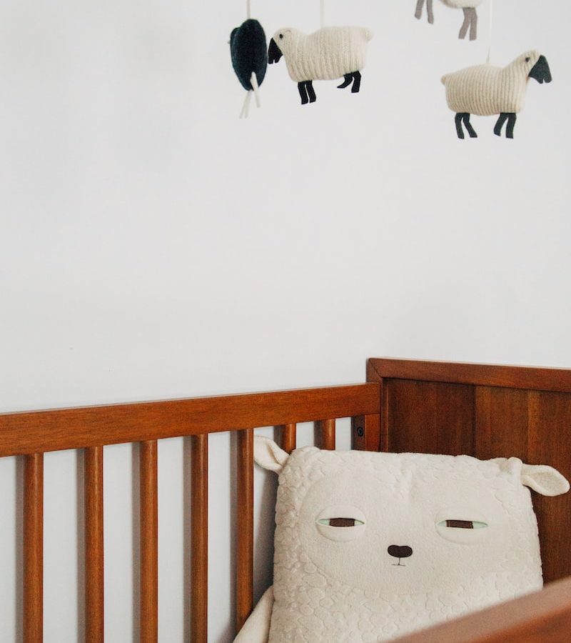 crib with sheep pillow and crib mobile